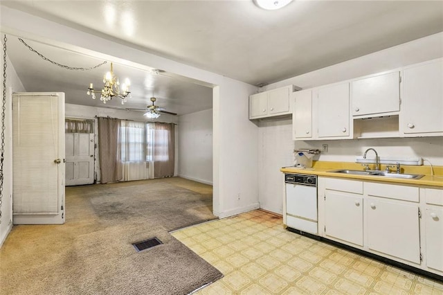 kitchen with visible vents, white cabinets, a sink, dishwasher, and baseboards