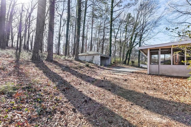 view of yard with a sunroom and an outdoor structure