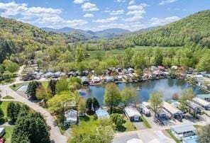 birds eye view of property featuring a water and mountain view