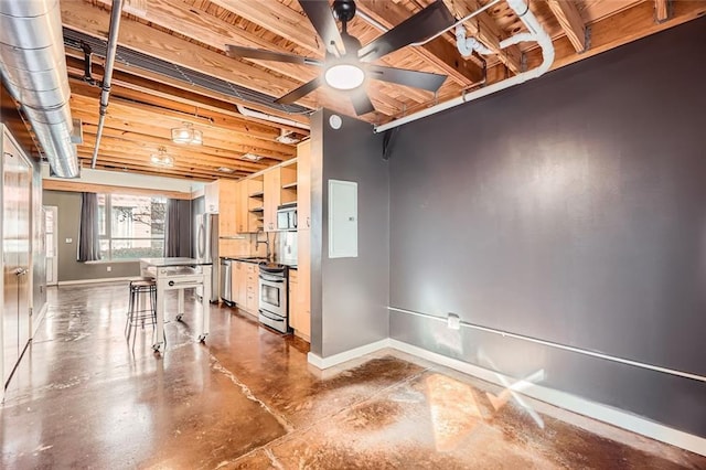 kitchen with concrete flooring, a breakfast bar, electric panel, ceiling fan, and stainless steel appliances