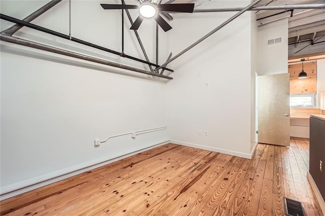 empty room featuring ceiling fan and light hardwood / wood-style floors