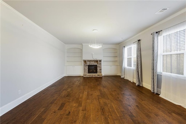 unfurnished living room featuring crown molding, dark wood-type flooring, built in features, and a stone fireplace