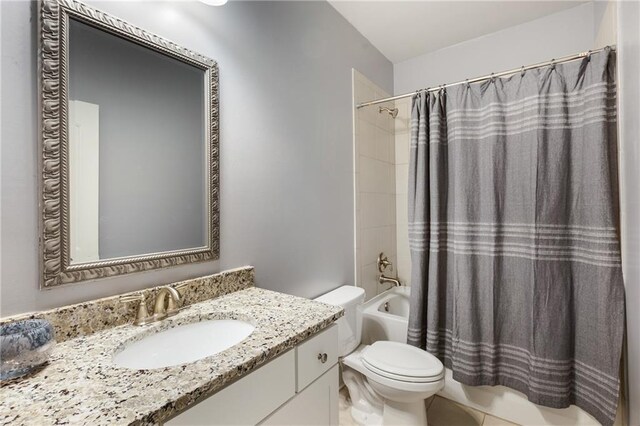 full bathroom featuring shower / bath combo, vanity, and toilet