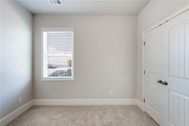 unfurnished room with light carpet