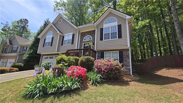 split foyer home with a garage and a front yard