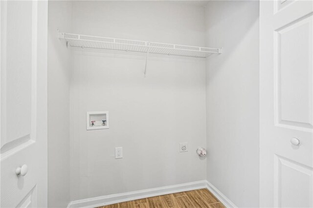 laundry room with wood-type flooring and hookup for a washing machine