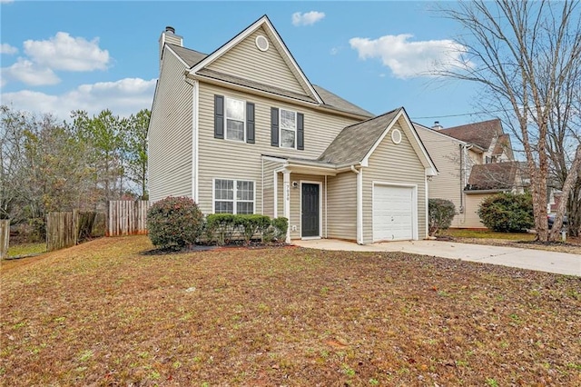 view of property featuring a garage and a front lawn