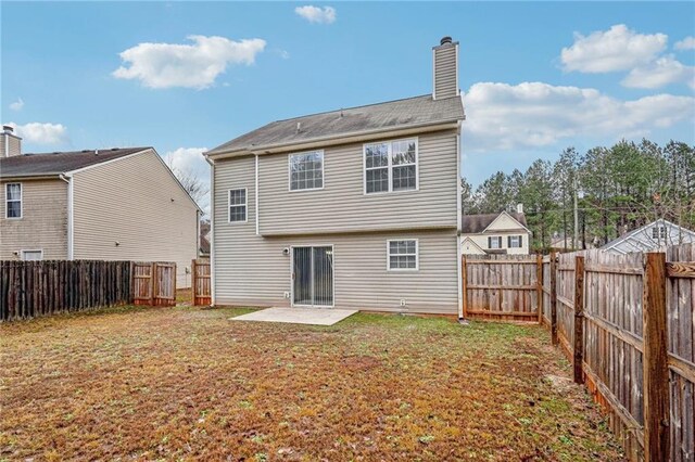 rear view of house featuring a patio area and a lawn