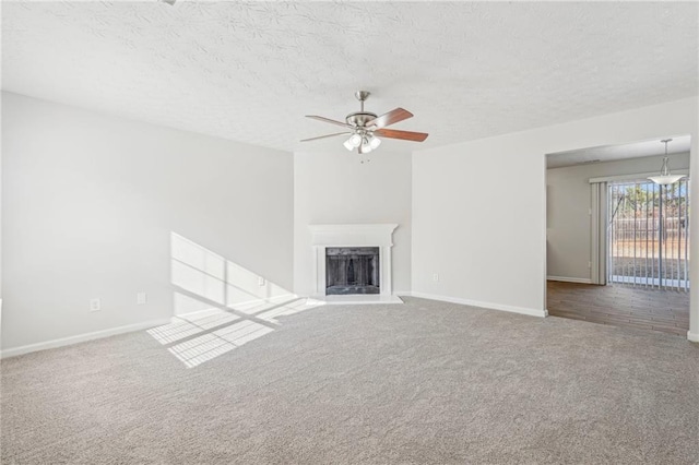 unfurnished living room featuring carpet, a textured ceiling, and ceiling fan