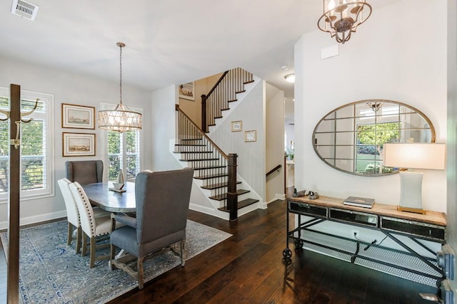 dining room with an inviting chandelier and dark hardwood / wood-style floors