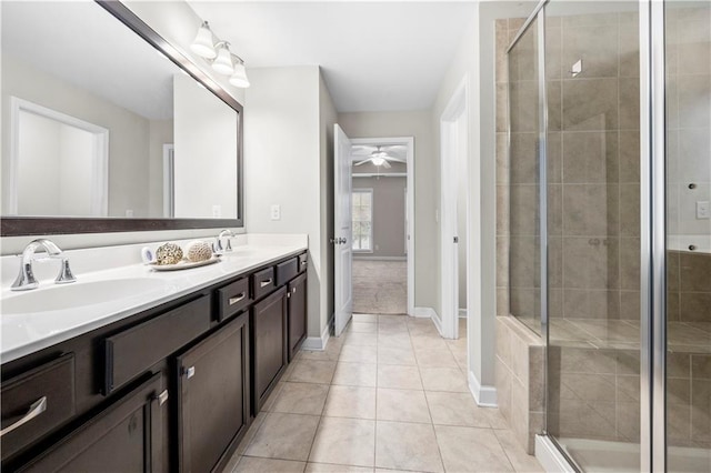 bathroom featuring tile patterned floors, vanity, ceiling fan, and a shower with shower door