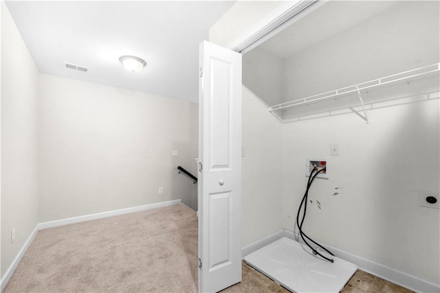 laundry room featuring washer hookup and light carpet