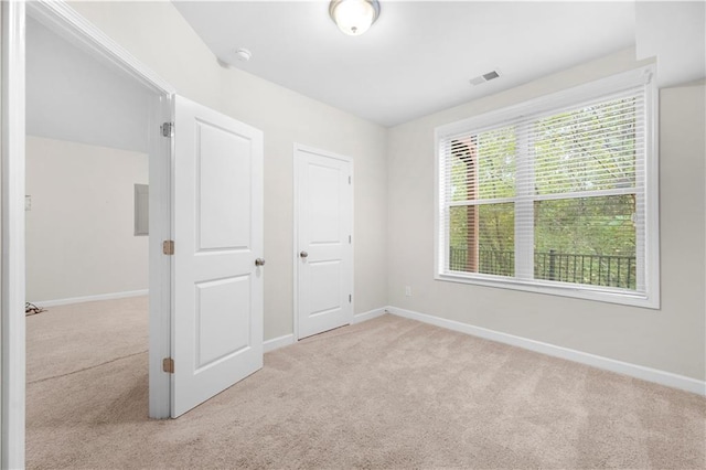 unfurnished bedroom with light colored carpet