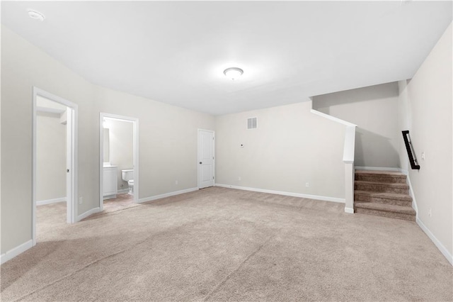 unfurnished living room featuring light colored carpet