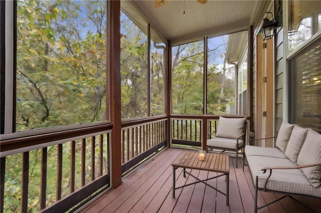 unfurnished sunroom with ceiling fan