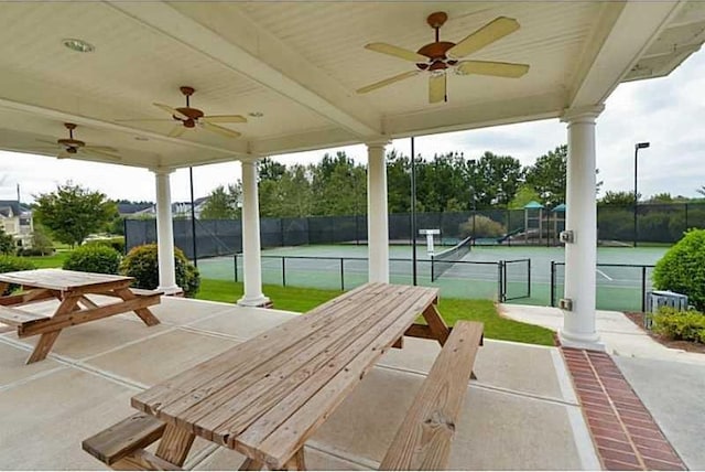 view of patio with ceiling fan and tennis court