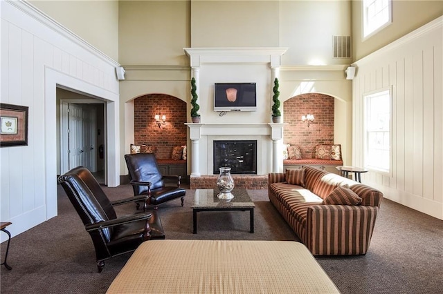 carpeted living room featuring a high ceiling