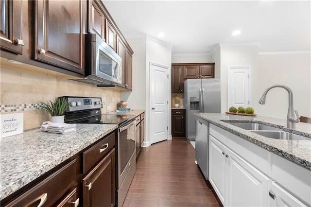 kitchen featuring sink, appliances with stainless steel finishes, dark brown cabinets, white cabinets, and ornamental molding