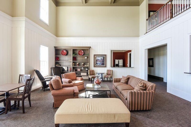 carpeted living room with a high ceiling