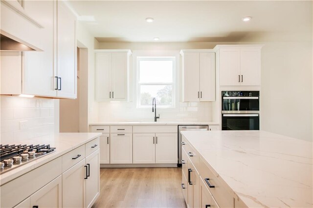 4202 Adler Cir, Buford, GA 30519 - kitchen with visible vents, a kitchen island, appliances with stainless steel finishes, a sink, and custom range hood