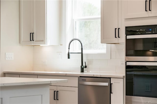 4202 Adler Cir, Buford, GA 30519 - kitchen with custom exhaust hood, backsplash, light stone countertops, light wood-style floors, and stainless steel gas stovetop