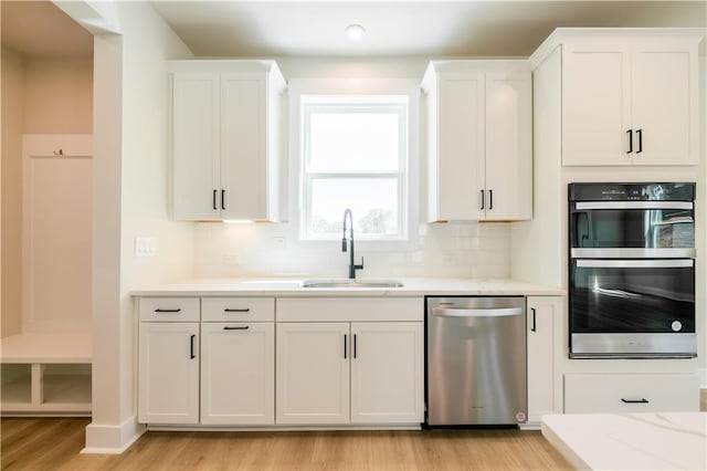 4202 Adler Cir, Buford, GA 30519 - kitchen with white cabinetry, backsplash, appliances with stainless steel finishes, and light stone counters