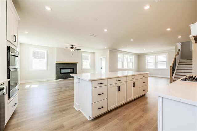 4202 Adler Cir, Buford, GA 30519 - kitchen with light wood-style flooring, white cabinetry, double wall oven, dishwasher, and a sink