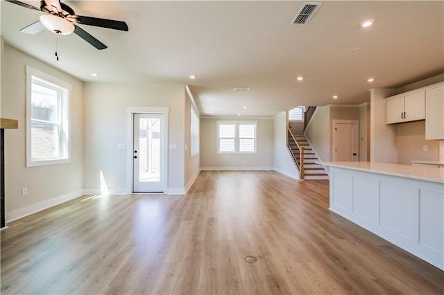 4202 Adler Cir, Buford, GA 30519 - kitchen featuring open floor plan, appliances with stainless steel finishes, a ceiling fan, a kitchen island, and a premium fireplace