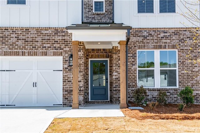 4202 Adler Cir, Buford, GA 30519 - view of front of home featuring board and batten siding, a front lawn, brick siding, and concrete driveway