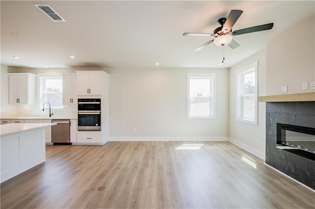 4202 Adler Cir, Buford, GA 30519 - interior details with a premium fireplace, wood finished floors, baseboards, and a ceiling fan