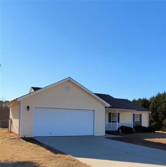 ranch-style house with concrete driveway and an attached garage