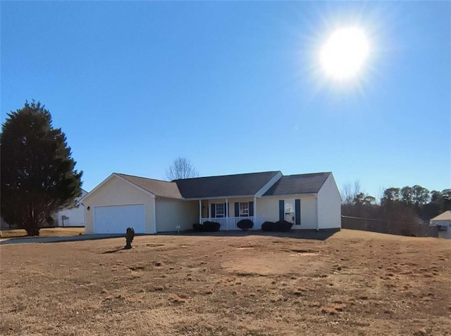 single story home featuring a garage and covered porch