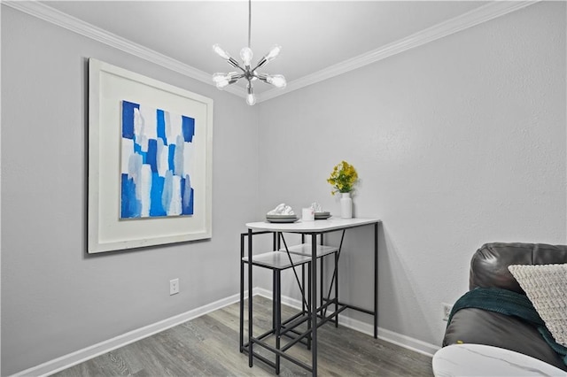dining area featuring a chandelier, wood finished floors, ornamental molding, and baseboards