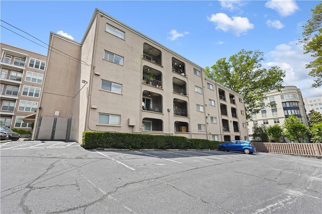 view of apartment building / complex with uncovered parking
