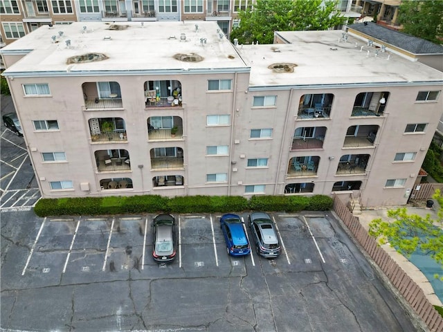 view of apartment building / complex with uncovered parking