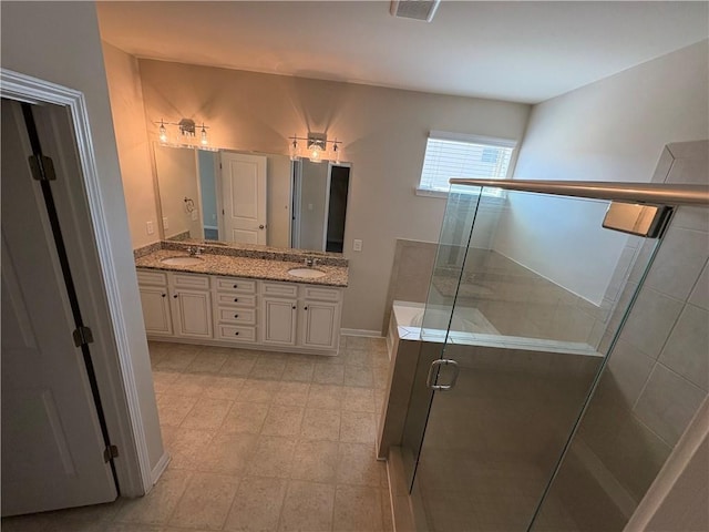 bathroom with double vanity, visible vents, a stall shower, and a sink