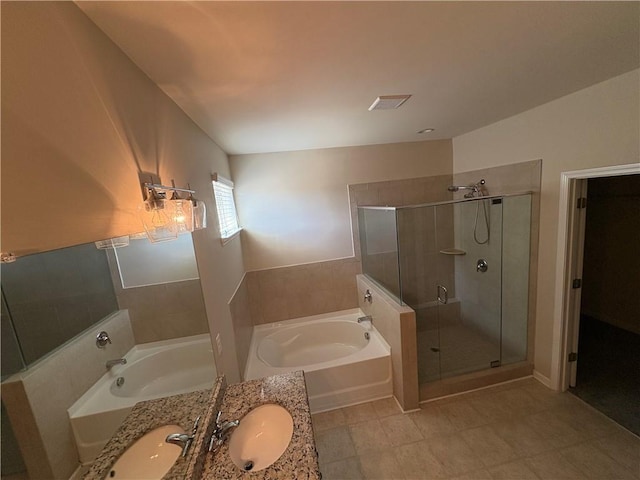 bathroom featuring visible vents, a stall shower, a garden tub, and a sink