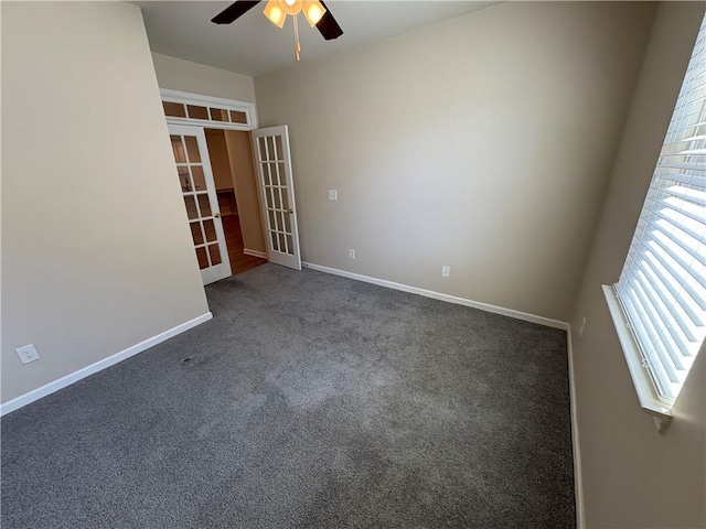 carpeted spare room with french doors, baseboards, and a ceiling fan