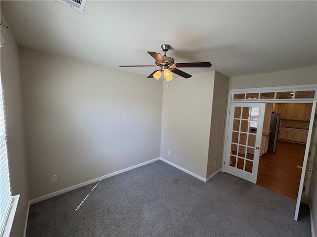 empty room featuring visible vents, ceiling fan, baseboards, carpet, and french doors