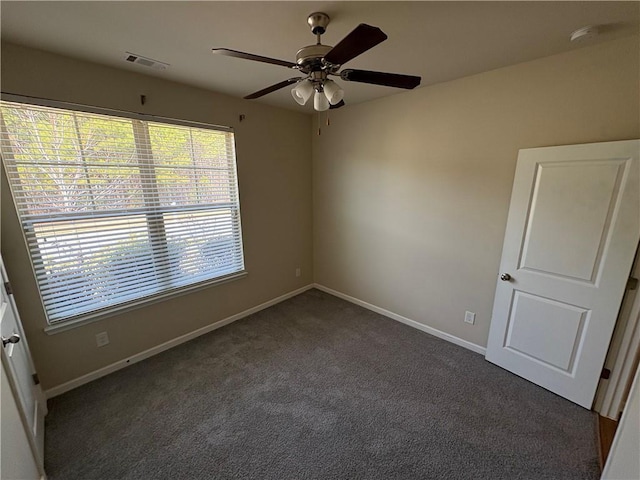 empty room with visible vents, baseboards, ceiling fan, and carpet flooring