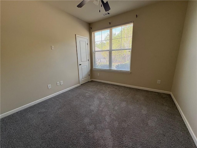 unfurnished room with a ceiling fan, baseboards, visible vents, and dark colored carpet