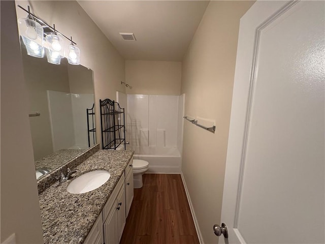 full bathroom featuring visible vents, toilet, wood finished floors, bathtub / shower combination, and vanity