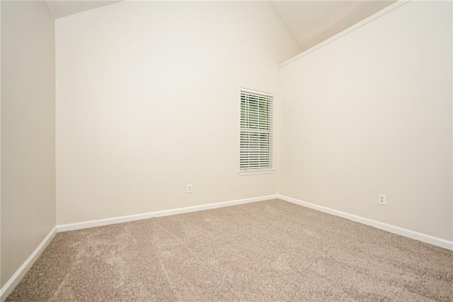 empty room featuring carpet floors and high vaulted ceiling