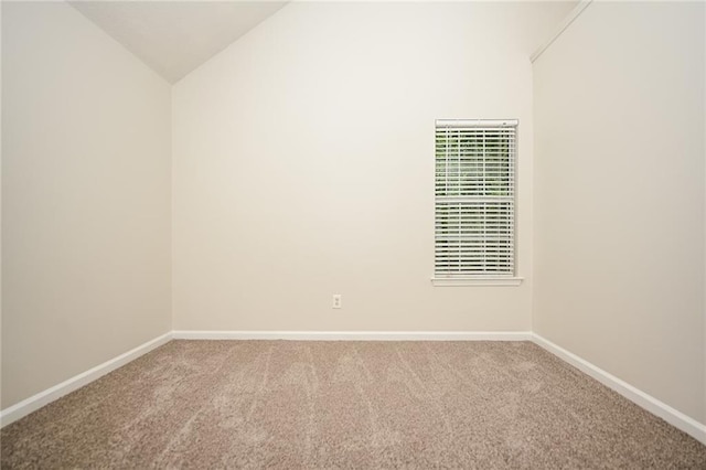 carpeted empty room with lofted ceiling