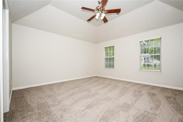 carpeted spare room featuring lofted ceiling and ceiling fan