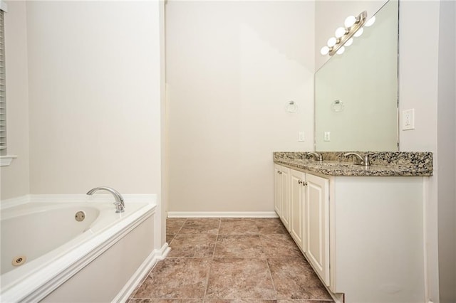 bathroom with vanity and a bath