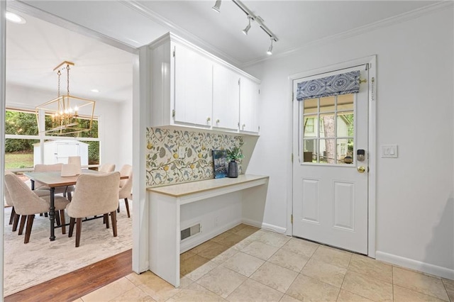 2800 Mornington Dr NW, Atlanta, GA 30327 - dining area featuring a chandelier, crown molding, rail lighting, and light tile patterned flooring