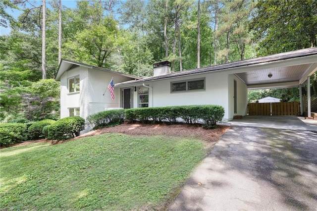 2800 Mornington Dr NW, Atlanta, GA 30327 - view of front of home with driveway, a chimney, a carport, and view of scattered trees
