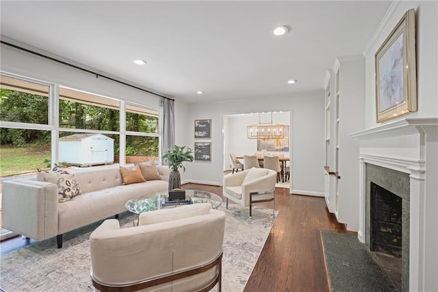 2800 Mornington Dr NW, Atlanta, GA 30327 - living room featuring a chandelier, dark wood-type flooring, recessed lighting, a fireplace, and crown molding