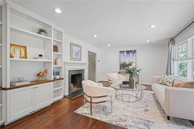 2800 Mornington Dr NW, Atlanta, GA 30327 - living area featuring dark wood finished floors, a high end fireplace, recessed lighting, crown molding, and built in features